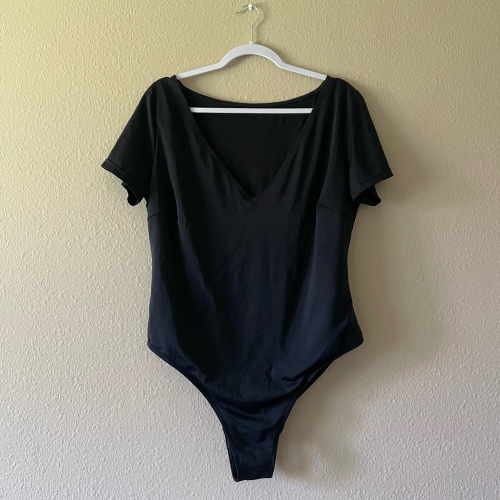 Black swimsuit with a deep v-neck and sleeves